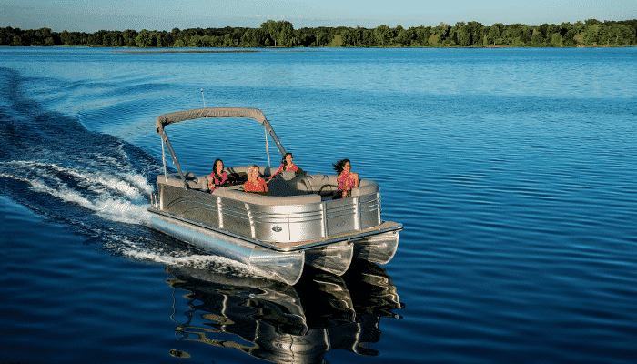 A pontoon boat cruising over calm waters