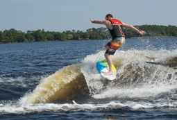 A man expertly surfing a wake on a wake board